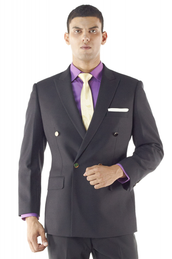 A bespoke double breasted four button suit jacket with tailor made one closure button, handmade peak lapels, a boutonniere on the left lapel, a stylish made to order upper welt pocket, and tailored side vents.